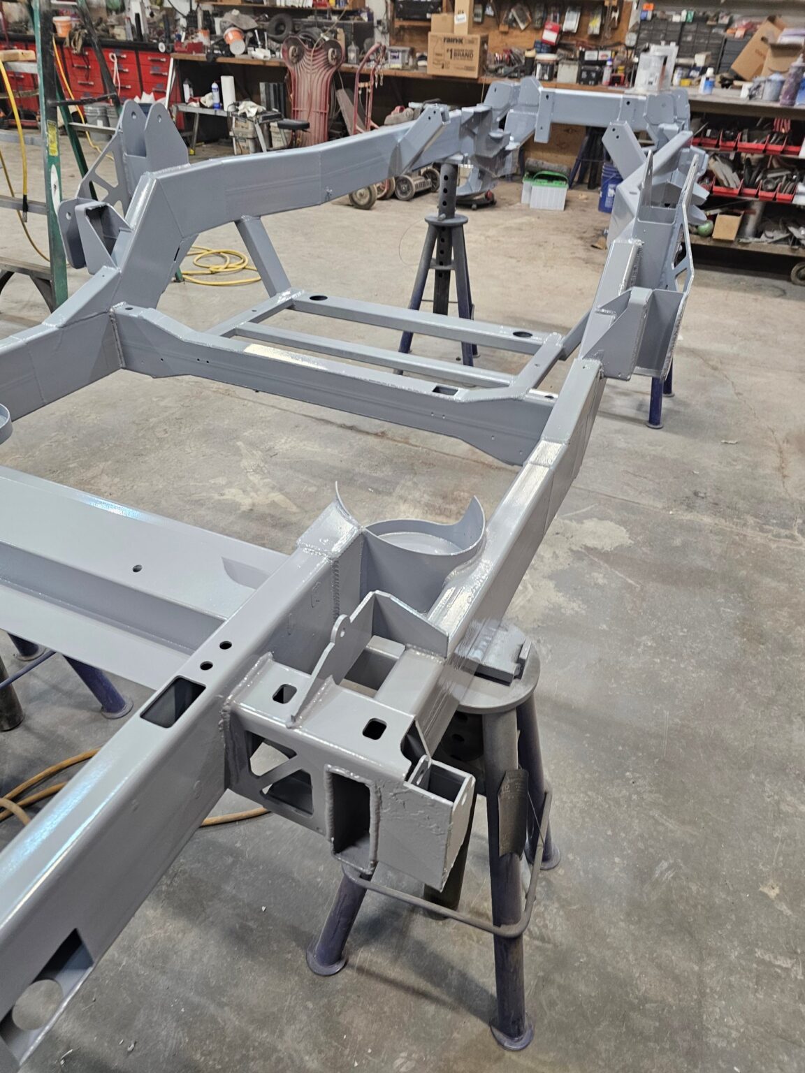 Frame-Werx chassis frame in primer on stands