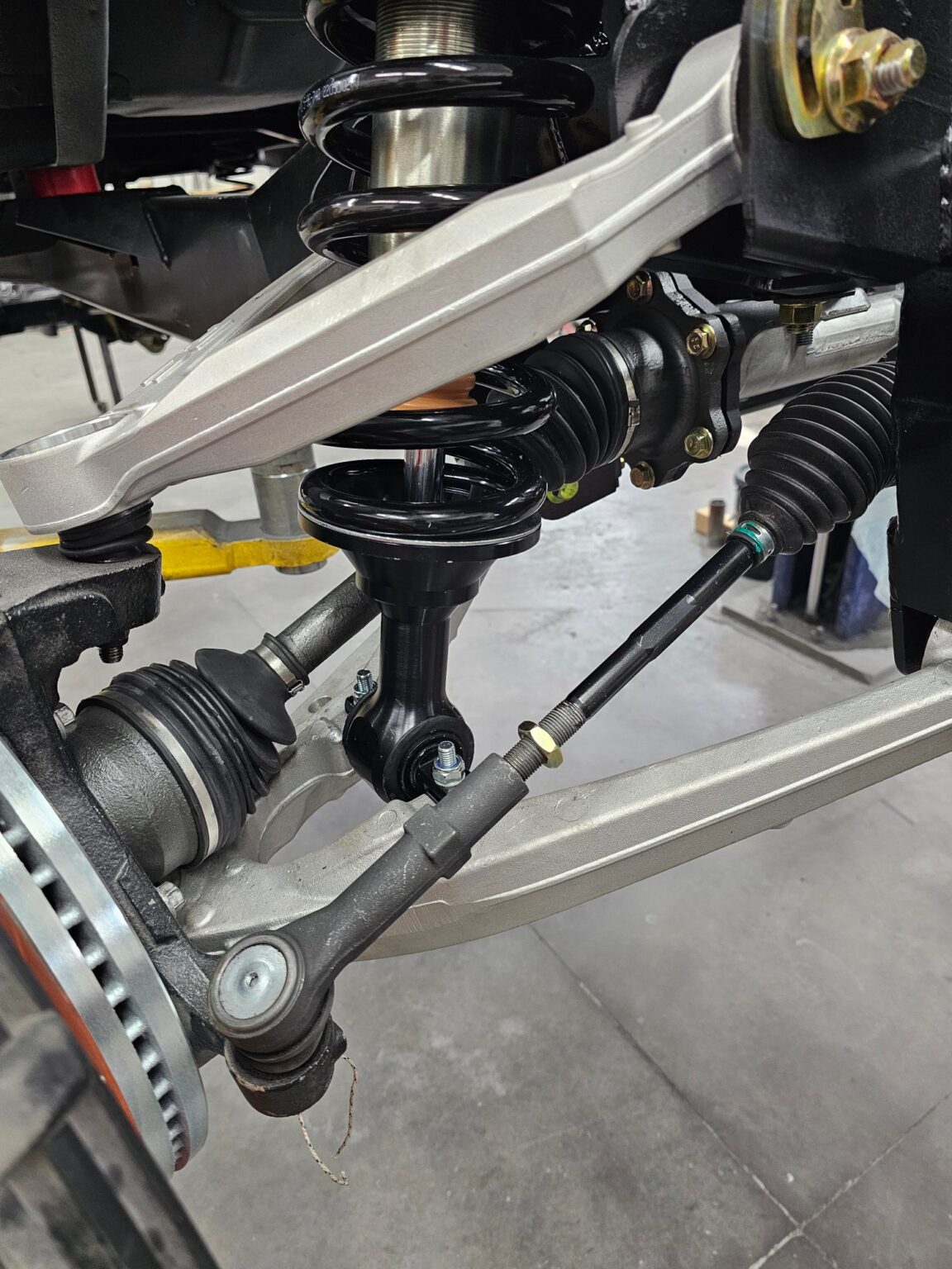 Frame-Werx front suspension control arm and axle