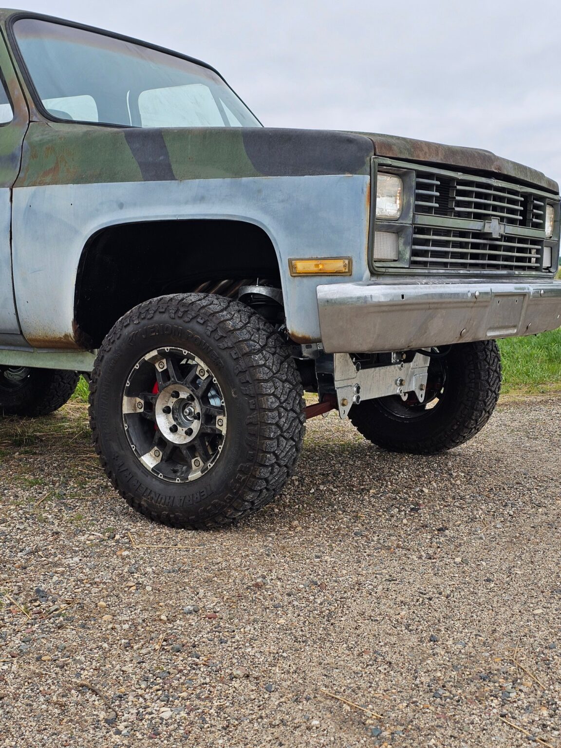 Front wheel of a K5 Blazer on a Frame-Werx IFS chassis, galvanized front suspension visible